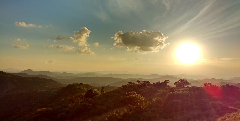 A stunning view of Mathikettan Shola Park in Kerala during sunset covered with dense clouds.