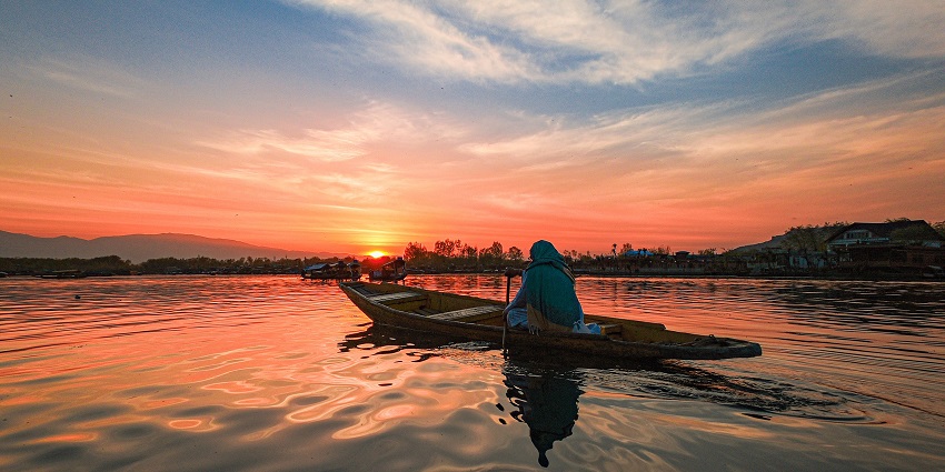 Mesmerising sunset view with a person enjoying boating at Dal Lake