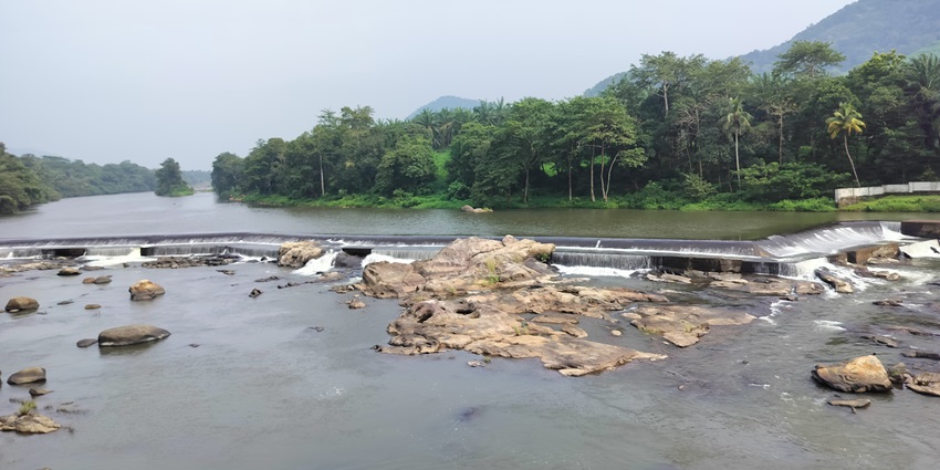 Dam with its calm reservoir - best places to visit near Chalakudy waterfalls Kerala