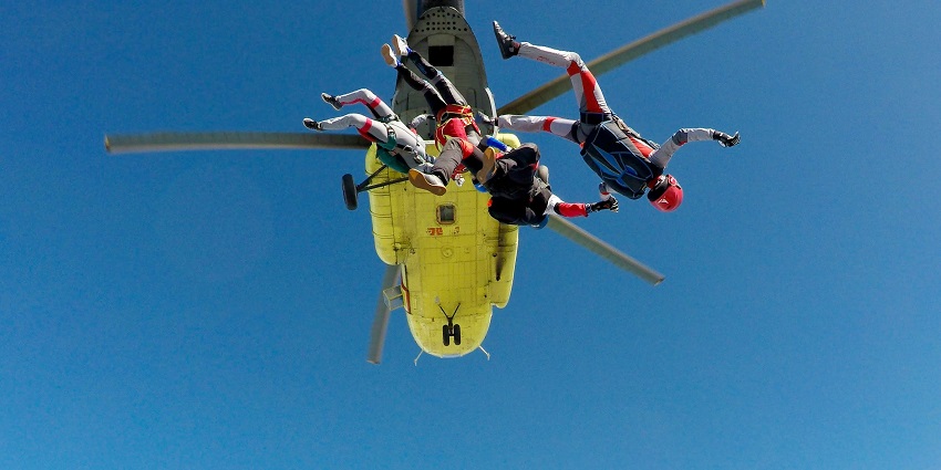 Picture of 3 adventure lovers performing skydiving in India amidst the scenic views.