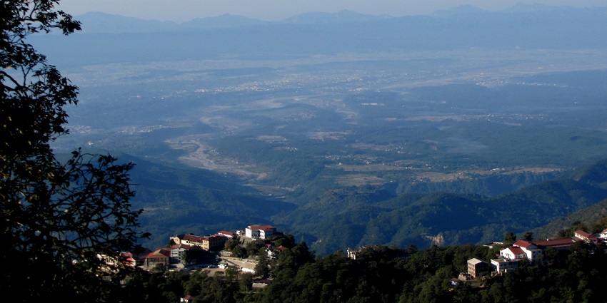 View of beautiful Dehradun Valley from Landour, lush green mountains and misty weather