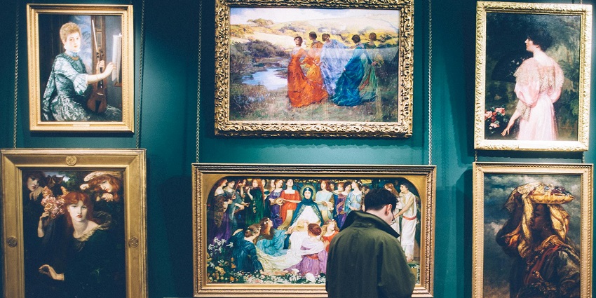A picture of a man admiring the historical artefacts and paintings at a museum in Guruvayur