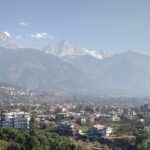 View of Dharamshala, one of the places to visit in July with the backdrop of snow-capped hills