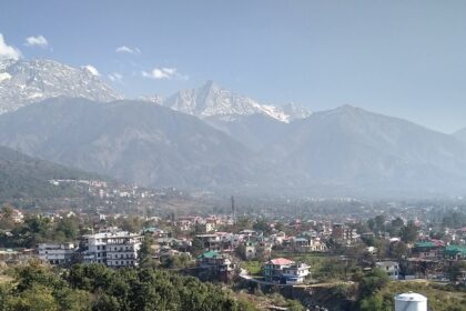 View of Dharamshala, one of the places to visit in July with the backdrop of snow-capped hills