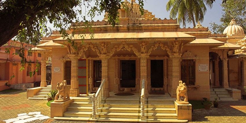 Front view of Kerala’s Dharmanath Jain Temple: ornate entrance set within lush greenery