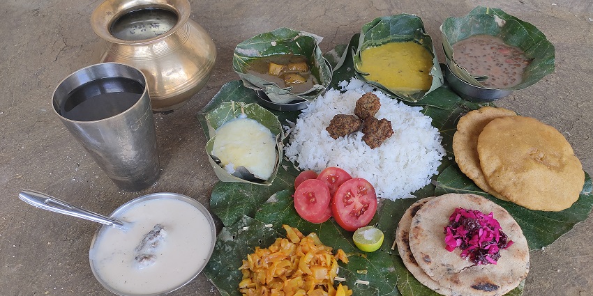 A picture of authentic Dogra food served in a traditional way in utensils made of leaves