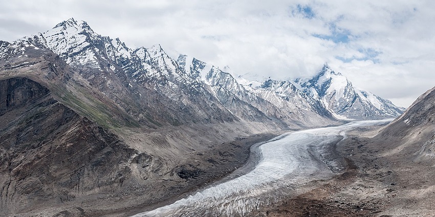 Drang Drung glacier seen from Pensi La Pass, with scanty snow on mountains on each side.