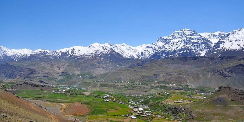 Panoramic view of Drass town with Tololing Range's snow-capped peaks in the background