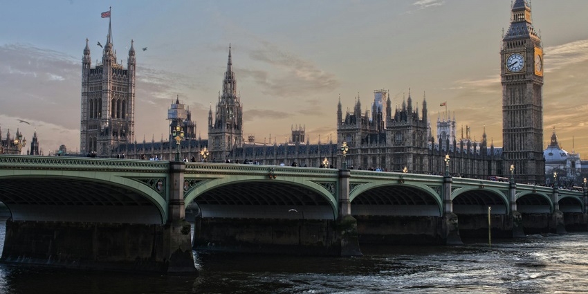 A breathtaking view of a bridge over a river in England with skyscraping buildings