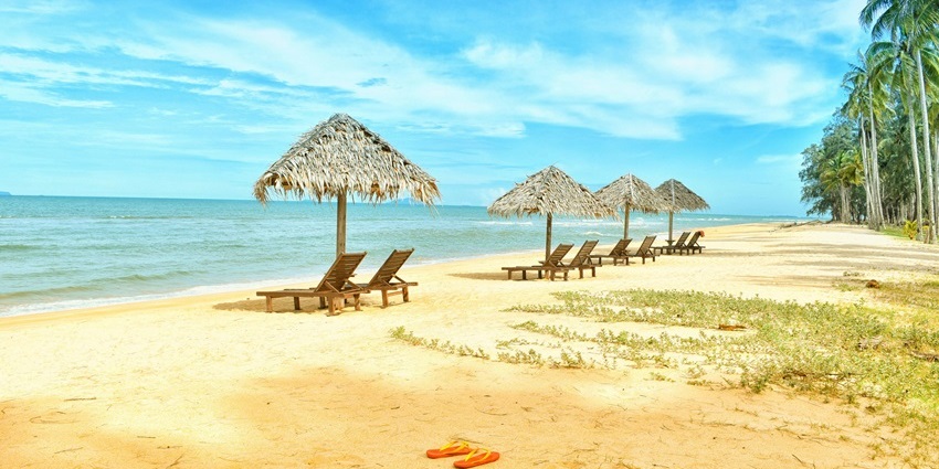 Relax and sunbathe on the golden sands of Kala Pathar Beach under clear blue skies.