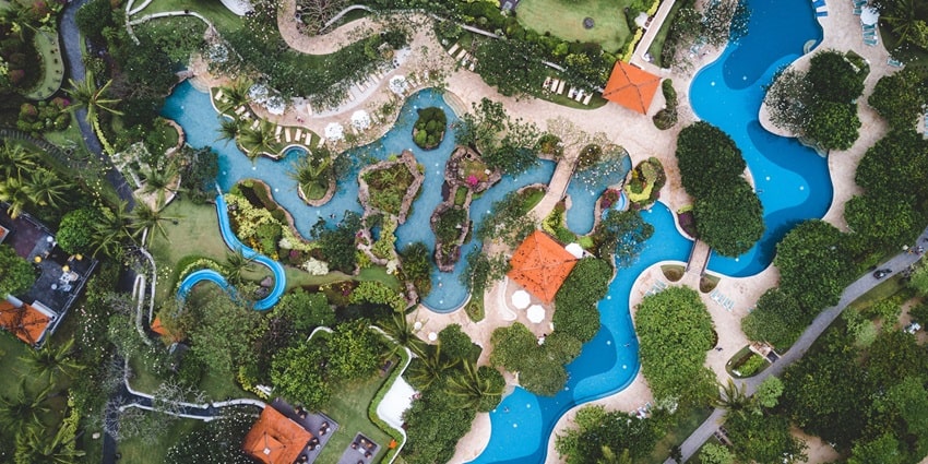 Aerial view of a beautiful enthralling waterpark surrounded by lush greenery and waters