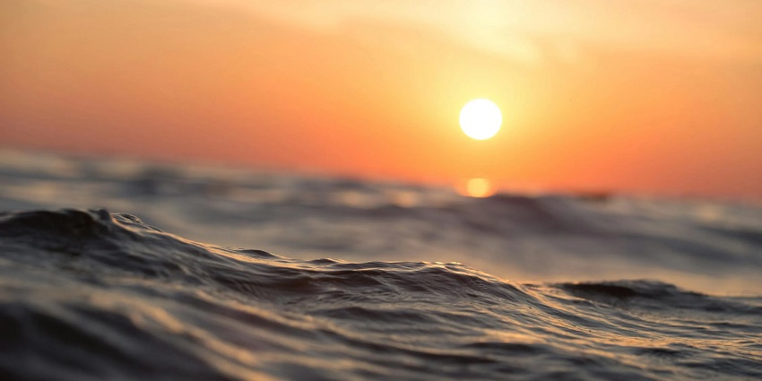 A mesmerising view of a body of water during the golden hour with low tide waves.