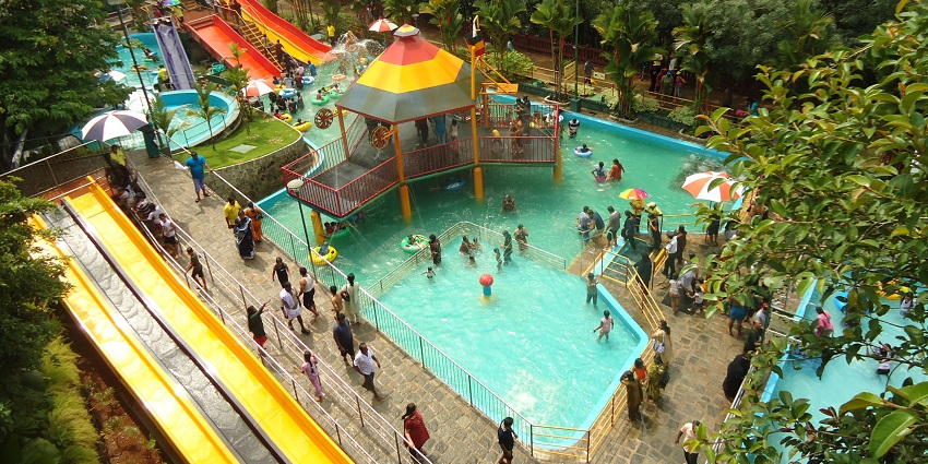 People enjoying a swimming pool at a water park