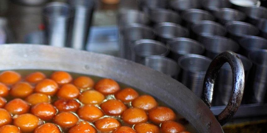 A picture of gulab jamuns in a sweet shop taken during a food festival in Vaishno Devi, Katra