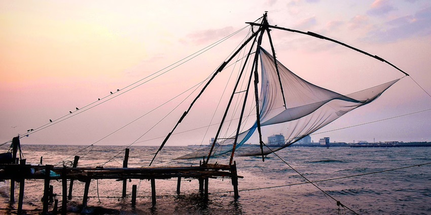 A happening evening view of the Fort Kochi Beach in Kerala with Chinese fishing nets.