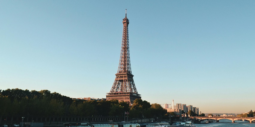 Scenic view of the sky-high Eiffel Tower in Paris, France, with boats in the river nearby