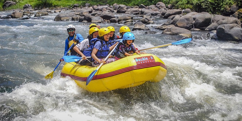 Enjoying fun rafting on a flowing river surrounded by nature - best things to do in Manali