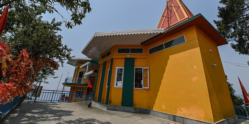 A breathtaking view of Ganesh Tok in East Sikkim with yellow walls and a tree near it.