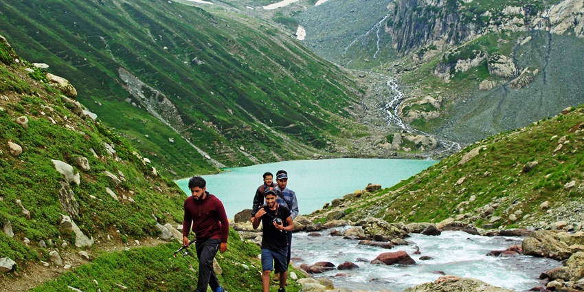Gangabal Lake hikers traversing scenic mountainous terrain near Amarnath Temple.