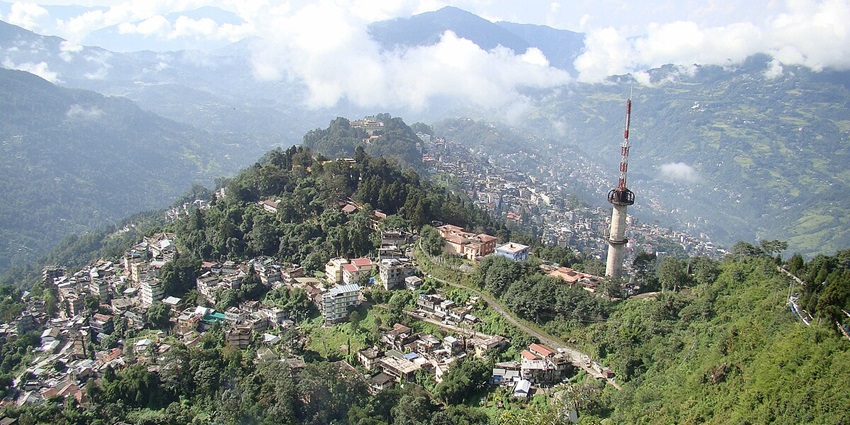 Scenic view of Gangtok from the mountains, showcasing its picturesque landscape.