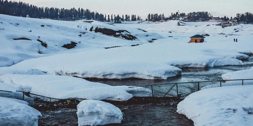 Snow-covered landscape in Gulmarg, featuring pristine white slopes and snowy trees