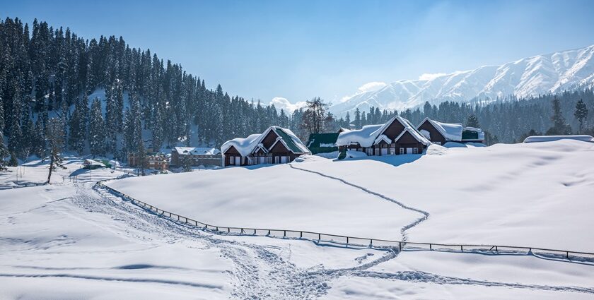 The backdrop of snow-capped mountains and lush green peaks in the beautiful Gulmarg