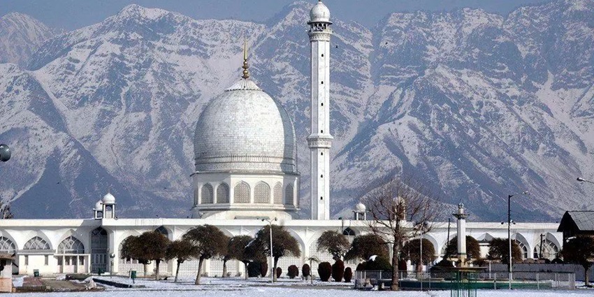 The archaic Hazratbal Shrine in winters with thick white snow covering it fully.