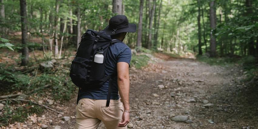 Man trekking in jungle with a bag pack things for trekking - Peechi Wildlife Sanctuary