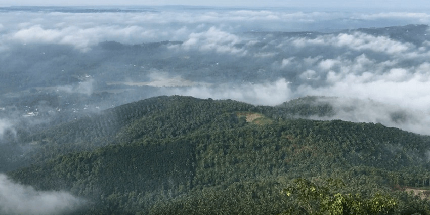 Aerial view of the foggy hill of Kerala - Chellarkovil waterfall in Kerala