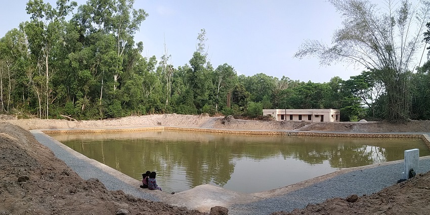 View of Hymavathi Pond nestled amidst serene surroundings, reflecting tranquil beauty.