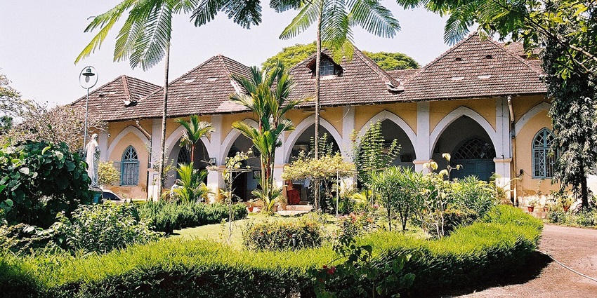 Exterior view of the Indo-Portuguese Museum building surrounded by trees in Kochi.