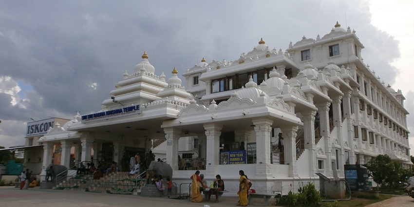 Perform traditional Hindu rituals at ISKCON, a famous temple in Abu Dhabi, UAE.