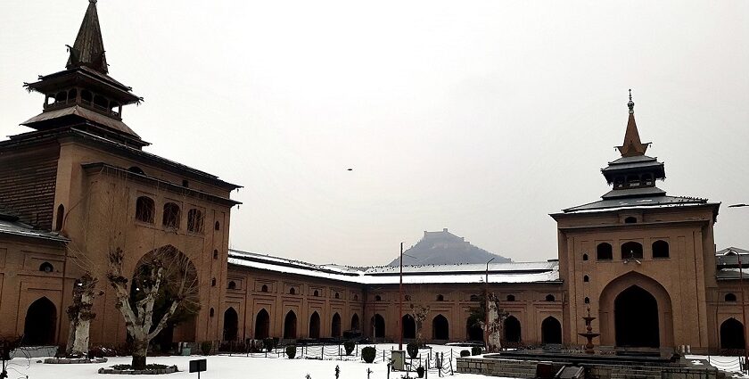 A serene view of the Jamia Masjid with its lofty entrance in the backdrop of winter.