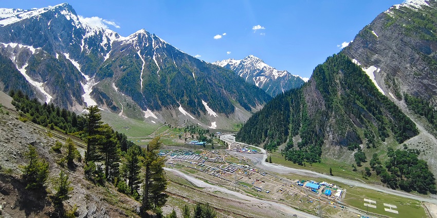 A lush mountain range with the backdrop of a base camp at Amarnath in Jammu and Kashmir