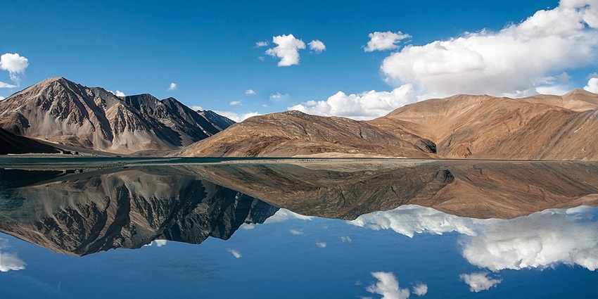 Serene lake surrounded by majestic mountains - places to visit in summer in India