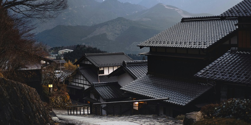 iew of houses in Japan with a breathtaking backdrop of lush green mountain peaks