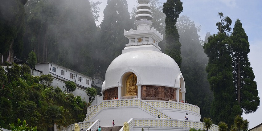 A view of the Japanese Temple with white and gold architecture during the daytime.
