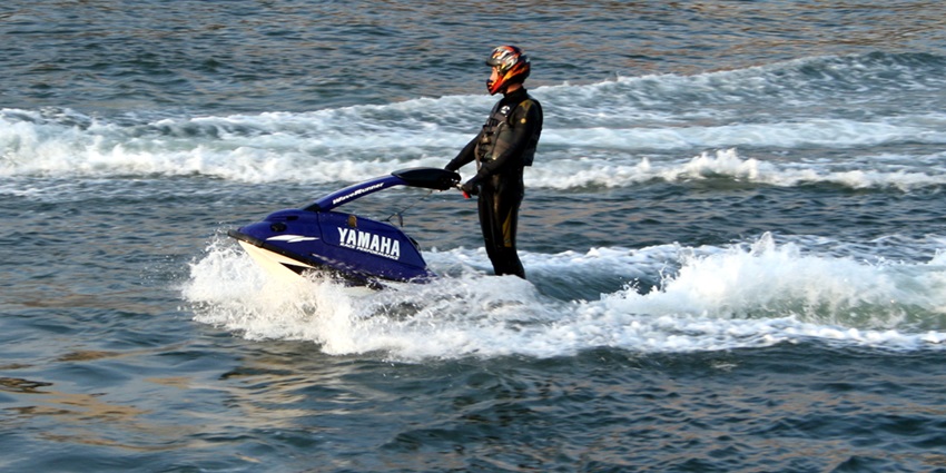 A person jet skiing in the middle of the shores of water, a must-do activity when in Andaman.