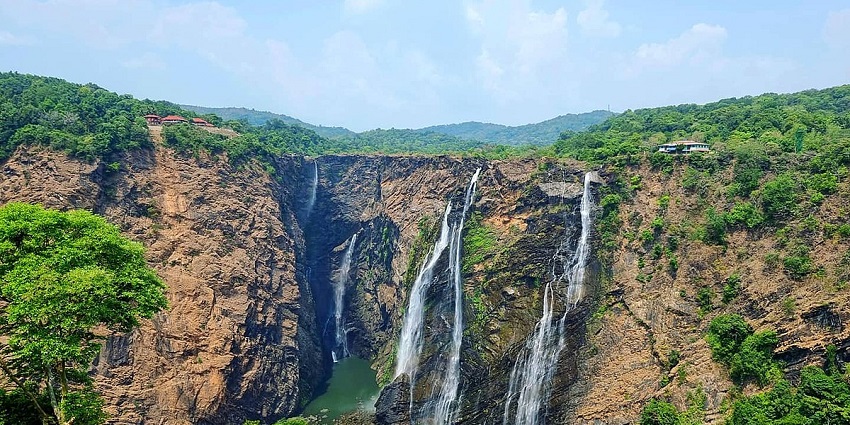 Majestic Jog Falls in Karnataka, cascading down rugged cliffs amidst lush greenery.