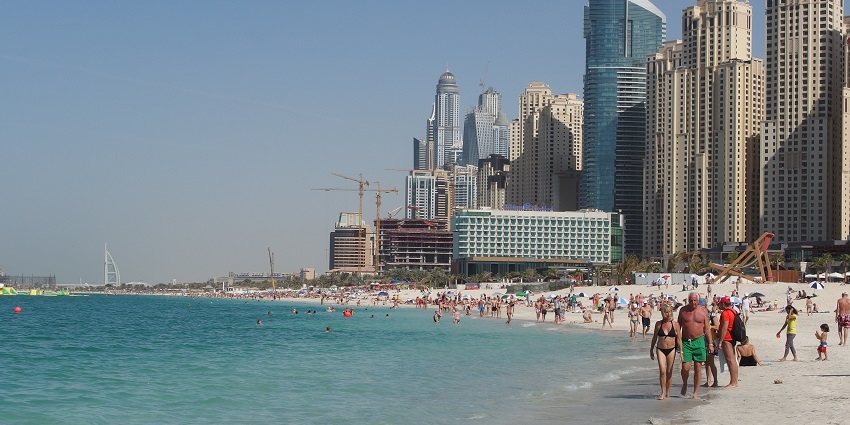 Picture of tourists strolling on the golden sand of beautiful Jumeirah Beach, UAE