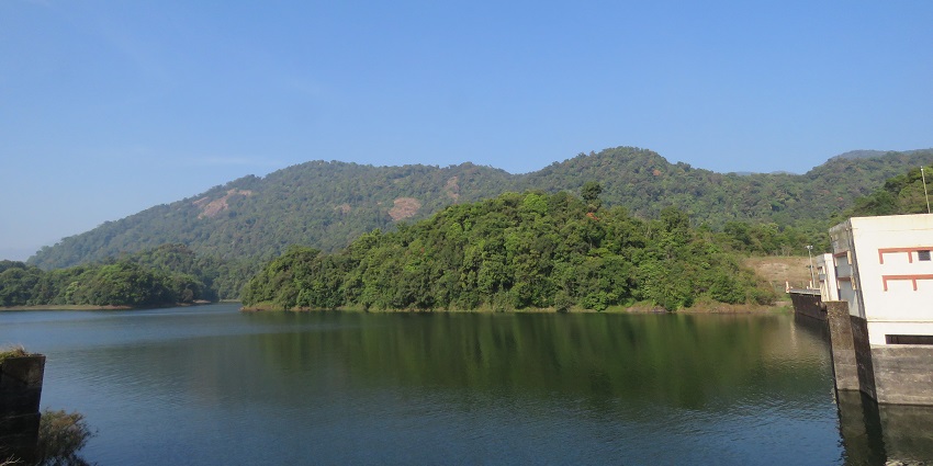 A breathtaking view of Kakkayam Dam covered during the daytime surrounded by greenery.