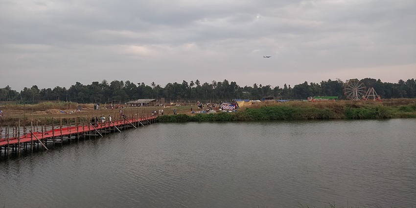 Bridge over the river with lush green trees in the background in Kalady, Ernakulam