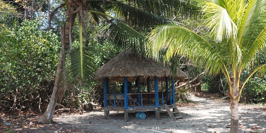 An image of a blue sky hovers over the serene shoreline of Kalipur Beach.