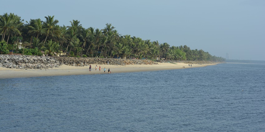 A scenic view of the Kappad Beach featuring shimmering blue waters and pristine sands.