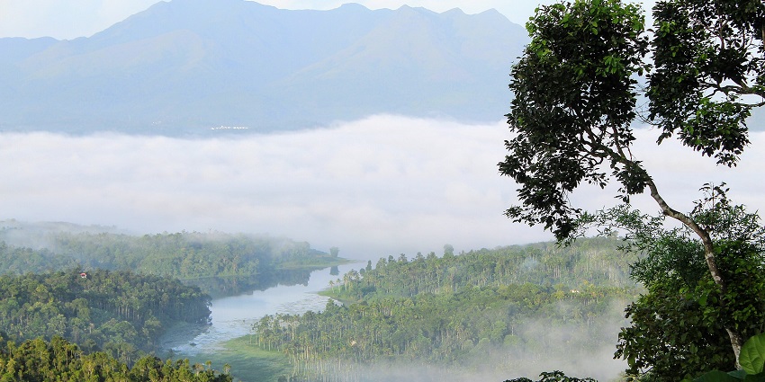 Karapuzha Dam in Wayanad with calm waters, surrounding hills, and lush greenery.
