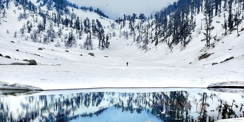 Picturesque view of the frozen Kareri lake, located amidst the embrace of Dhauladhar range.