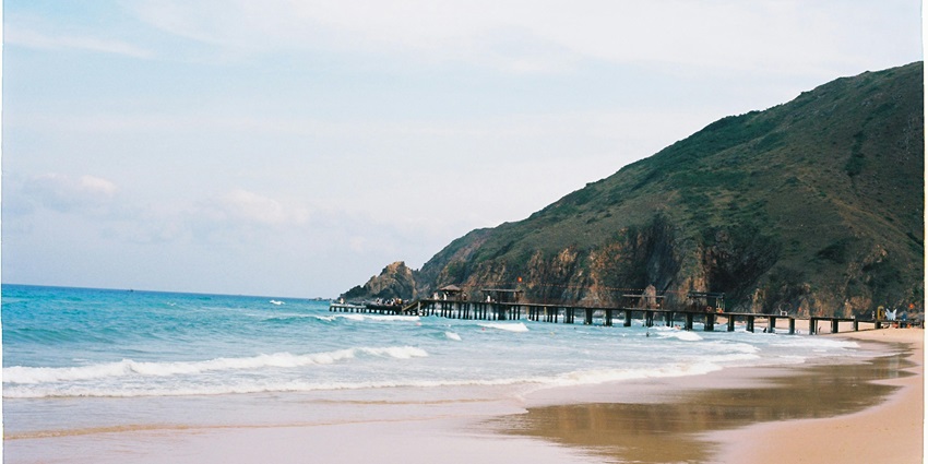 Image of Scenic Beach with Pier and Rocky Hillside - Places To Visit Around Galathea National Park