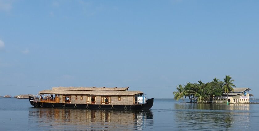 Houseboat on the picturesque backwater of Kerala with a backdrop of Coconut trees