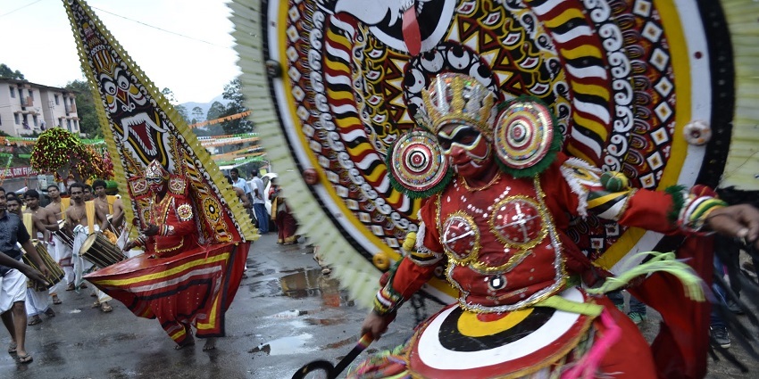 Colourful Kerala festival scene with traditional costumes and vibrant decorations.