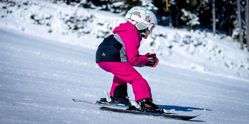 Kid skiing down snowy slopes, enjoying winter sports - one of the best things to in Kufri